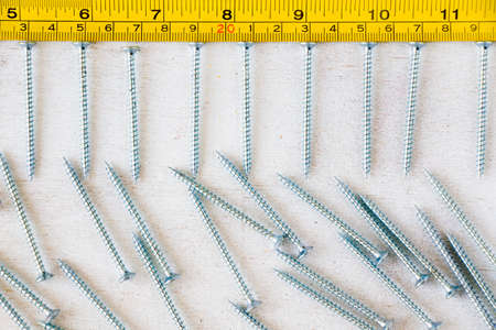 Metal ruler, centimeters and millimeters on the yellow ruler. Sizes.