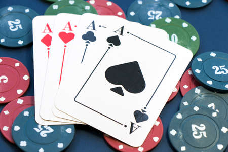 Four aces and chips, card game, cards on the table. Poker and blackjack, play cards.