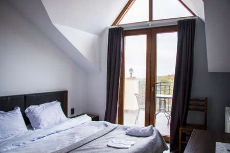 Guest house and hostel room interior, bed and table