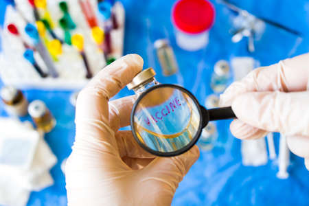 Corona virus and Covid - 19 new vaccine in ampules, doctor's hand whit white glove holding vaccine...