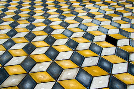 Geometry cubes optical illusion floor in the park of Tbilisi. Geometry figure background. Yellow and...