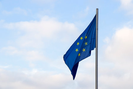 European union flag, flags waves and cloudy sky in Tbilisi