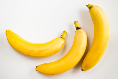 Banana on the white background, yellow and white colorsの写真素材