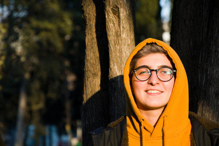 Young adult woman portrait at sunset in the park, Tbilisi, Georgiaの写真素材