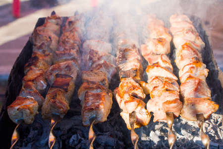 Georgian traditional dish, Mtsvadi on the fire, raw meal on the grill, barbeque in outdoorの写真素材