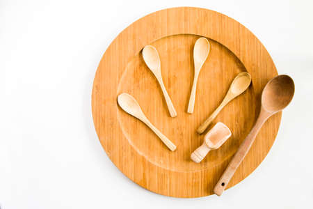 Empty wooden spoon and plate on the white backgroundの写真素材