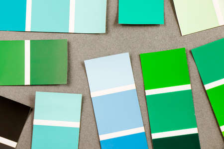 High angle view of color cards on the gray background, variation and gradient of green and blue colors.の写真素材