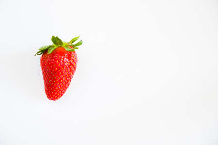 One strawberries on the white background, raw real strawberries, high angle viewの写真素材
