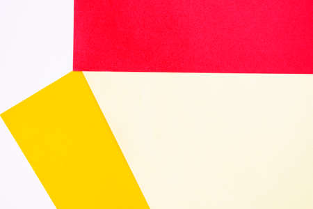 Colorful paper background, yellow and red paper board and geometric figures, pastel colored