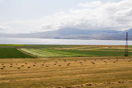 Haystacks and rolls, agriculture in Georgia, dry hay and mountain landscape with Faravani lake