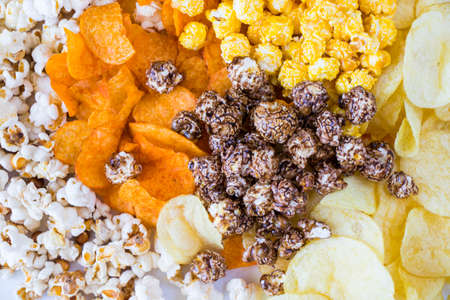 Fried popcorn and chips on the white background, low angle viewの写真素材