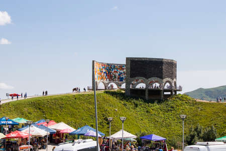 Khazbegi, Georgia - August 5, 2021: Open air market and shop on the hill, cars, people and marketplaceのeditorial素材