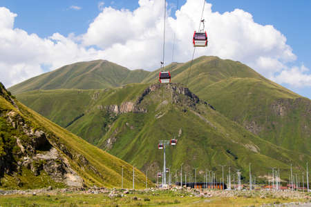 Air cabin and gondola lift transport, mountains and sunlight in Georgia