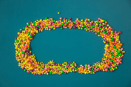 Candy on the blue table, colorful sweet candy background, high angle viewの写真素材