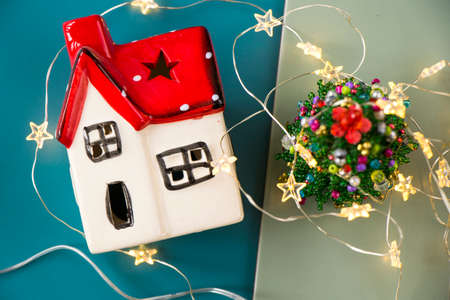New year toys, christmas tree and house on the blue background with star lights, christmas lightsの写真素材