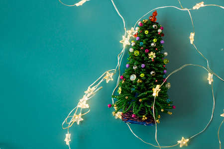 New year christmas tree on the blue background with star lights, christmas lights and pine tree toyの写真素材