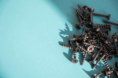 Black threaded screw on the green background, high angle viewの写真素材