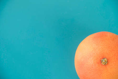 Grapefruit on the blue background, orange and blue colorsの写真素材