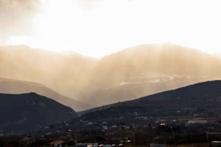 Mountain and town landscape during sunset in Kaspi, Georgiaの写真素材