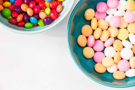 Colorful candies in the bowl, all color candies, white backgroundの写真素材
