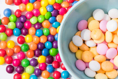Colorful candies in the bowl, all color candies, white background