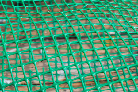 Plastic fence background, green fence close-up and texture