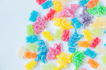 Dinosaurs and bear colorful jelly bonn, candies on the white background