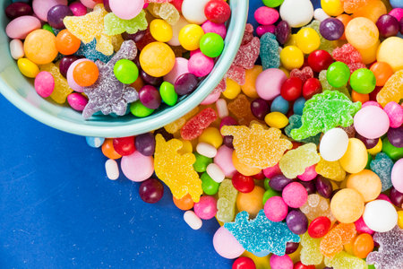 candies in the bowl, colorful candies background, large group of candiesの写真素材