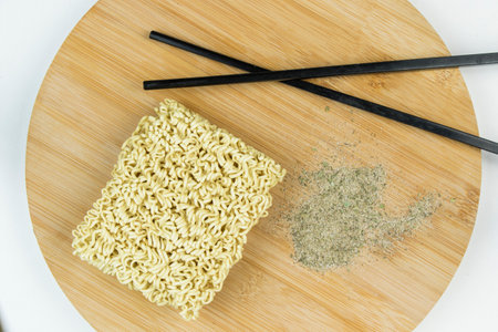 Fast food, chinese raw noodles with spices on the wooden backgroundの写真素材