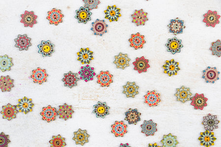 Colorful ornamental button on the white background, backdrop