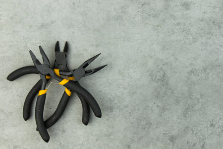 pliers set on the fray background, black different pliersの写真素材