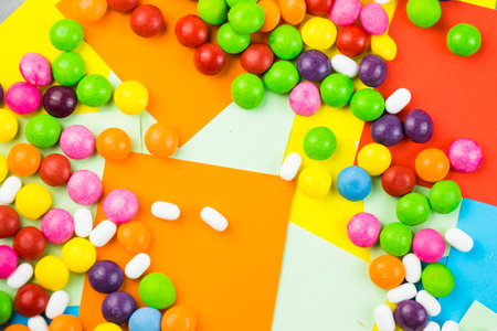 Skittles candy on the colorful table, colorful sweet candy backgroundの写真素材