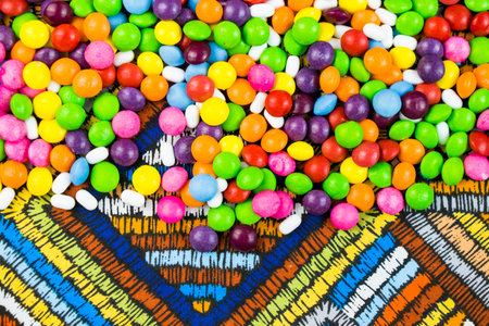 Skittles candy on the colorful table, colorful sweet candy backgroundの写真素材