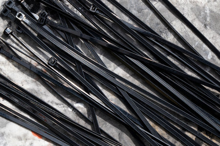 Black cable tie on the gray background