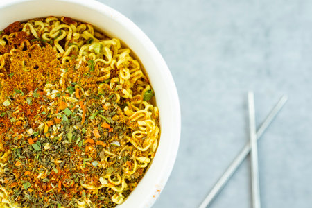 Fast food, raw and cocked chinese noodles with spicesの写真素材