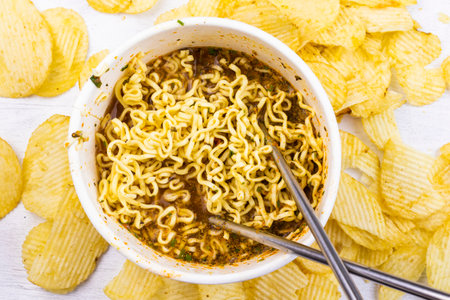 Fast food, raw and cocked chinese noodles with spicesの写真素材