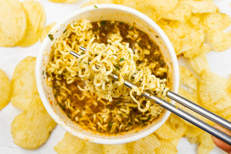 Fast food, raw and cocked chinese noodles with spicesの写真素材