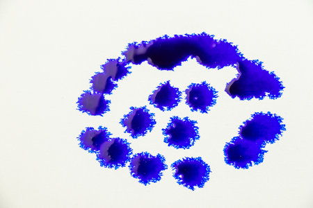 Blue color ink paint on the white backgroundの写真素材