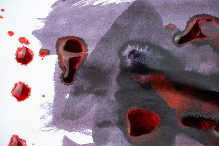 Red and purple color ink paint on the white backgroundの写真素材