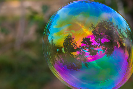 Soap bubbles in yard, colorful bubblesの写真素材