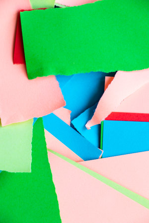 Wallpaper and background made from crumpled torn and colorful pieces of paper