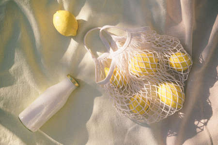 Lemons and kefir in a string bagの写真素材