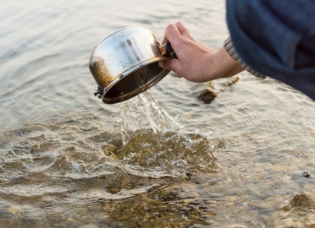 Someone wash pot in the river.の写真素材
