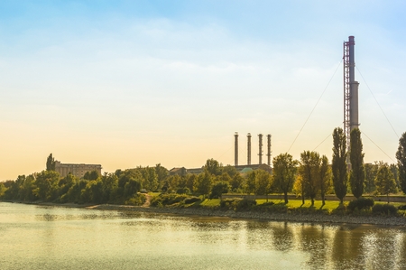 Thermal power plant with trees and blue sky.の写真素材
