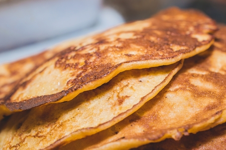 Pile of delicious american pancakes close up.