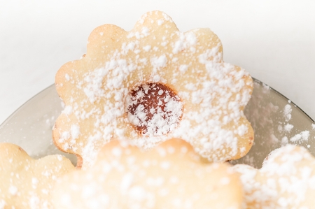 Homemade apricot jam Linzer with icing sugar on the white table close up top view.の写真素材