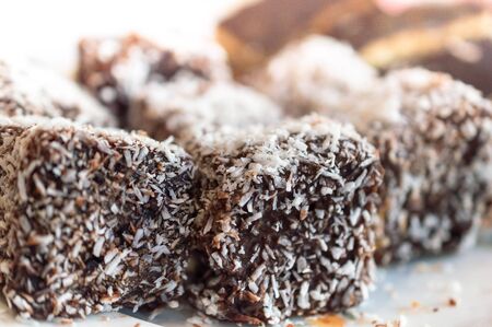 Close up of chocolate cakes cubes with coconut flourの写真素材