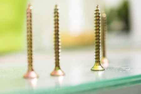 Group of golden screws standing on tableの写真素材