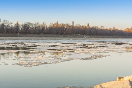 Winter landscape sunset on the ice of the river