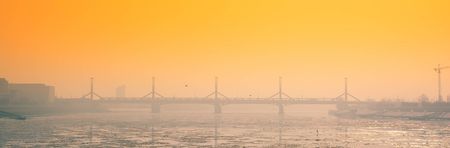 Winter frozen city sunset landscape with bridgeの写真素材